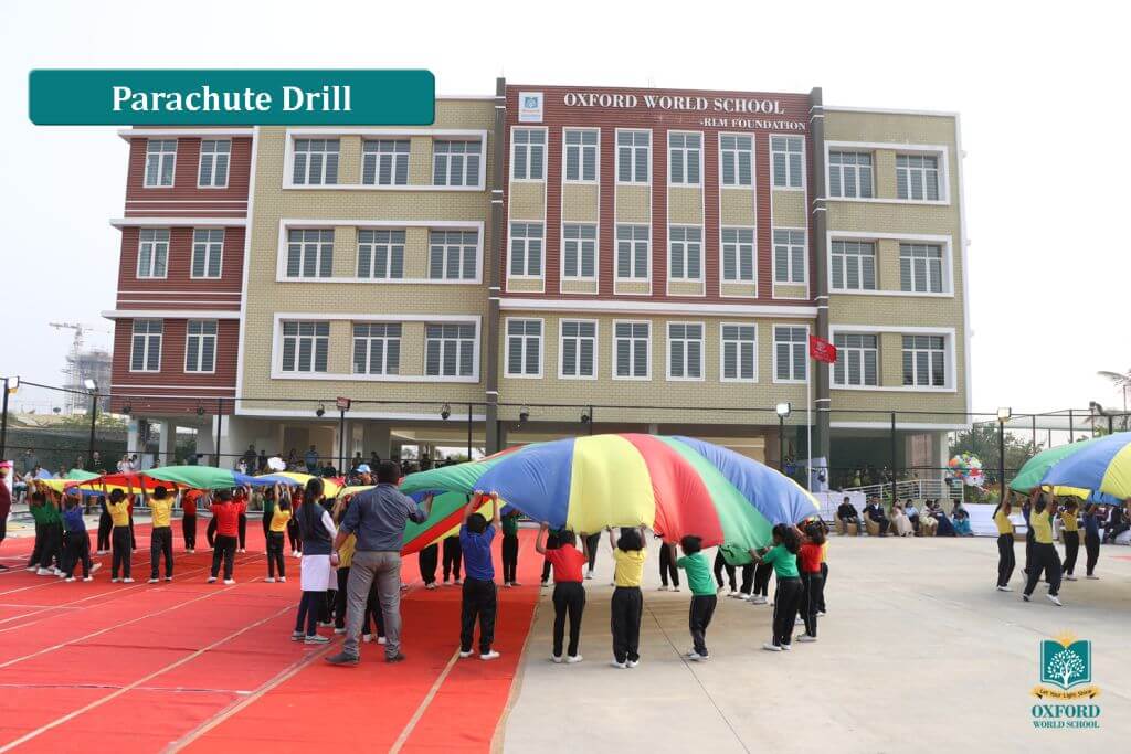 students parachute drill activity on oxford world school playground